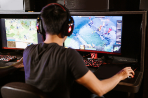 A young man gaming at a computer