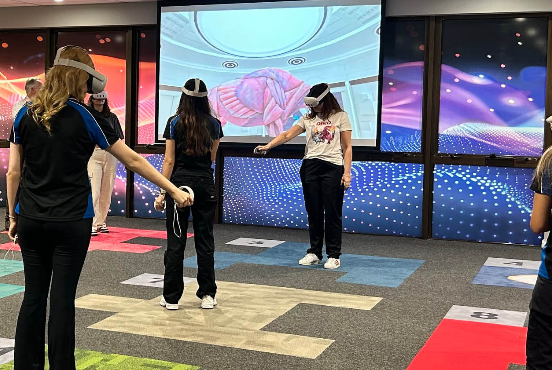 Three students working with VR headsets at TAFE