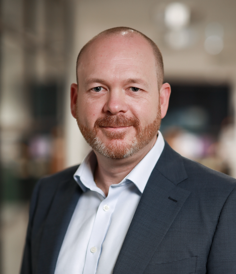 Chris Lamb headshot in a business suit