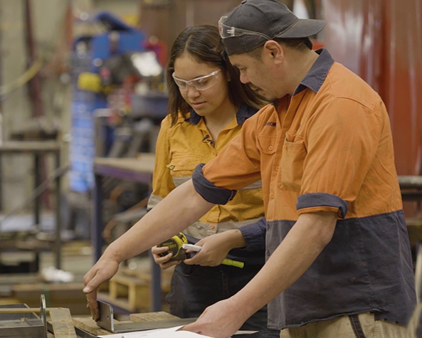 A women and a man employee working together in a workshop setting